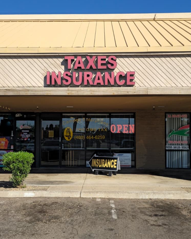 The InsureMeBetter office entrance, under a red Taxes and Insurance sign